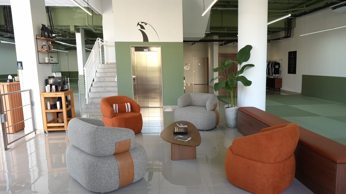 Lounge e recepção da Alliance Botânico, com elevador e acesso ao tatame